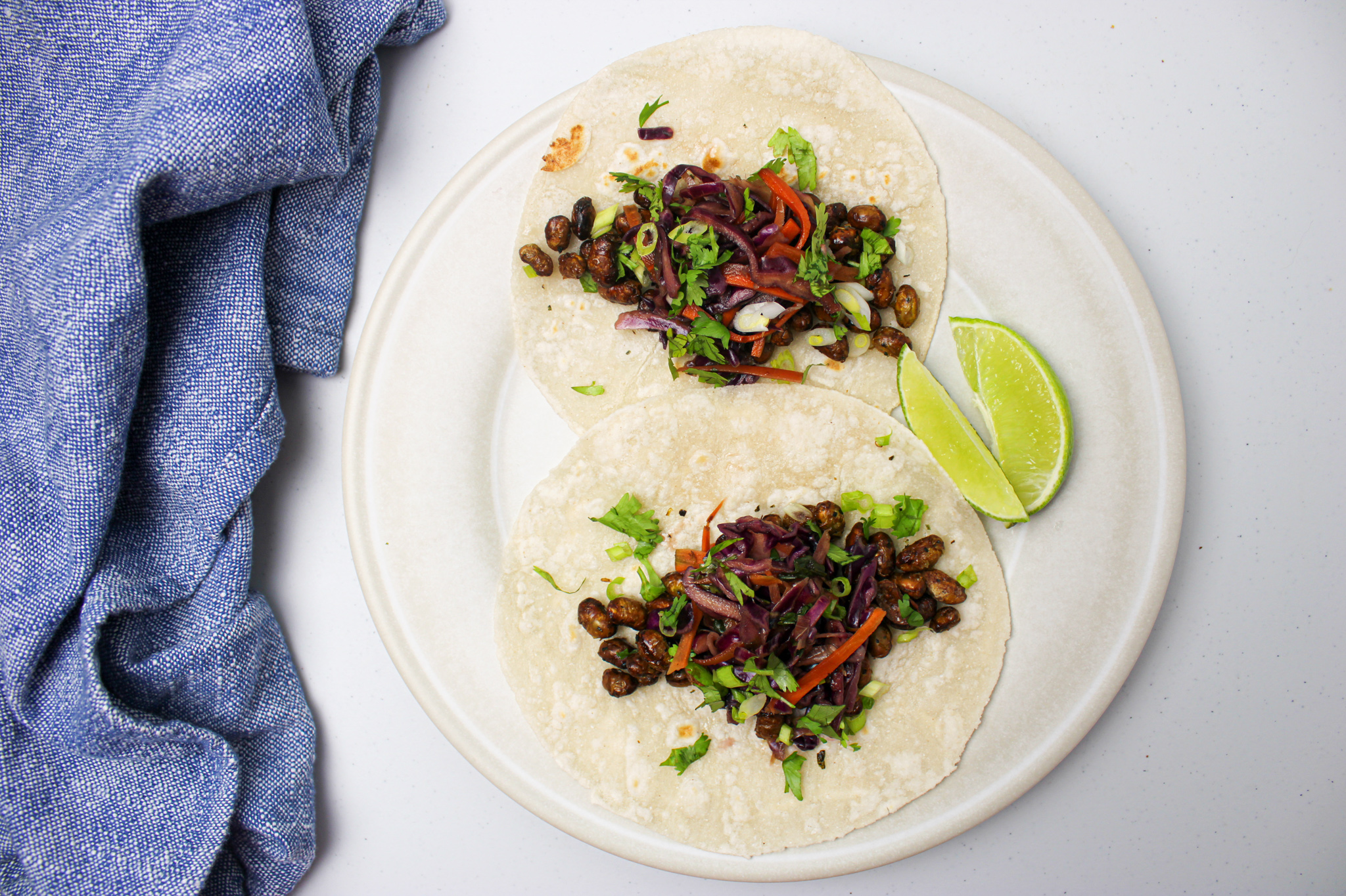 Tacos filled with crispy edamame and asian slaw